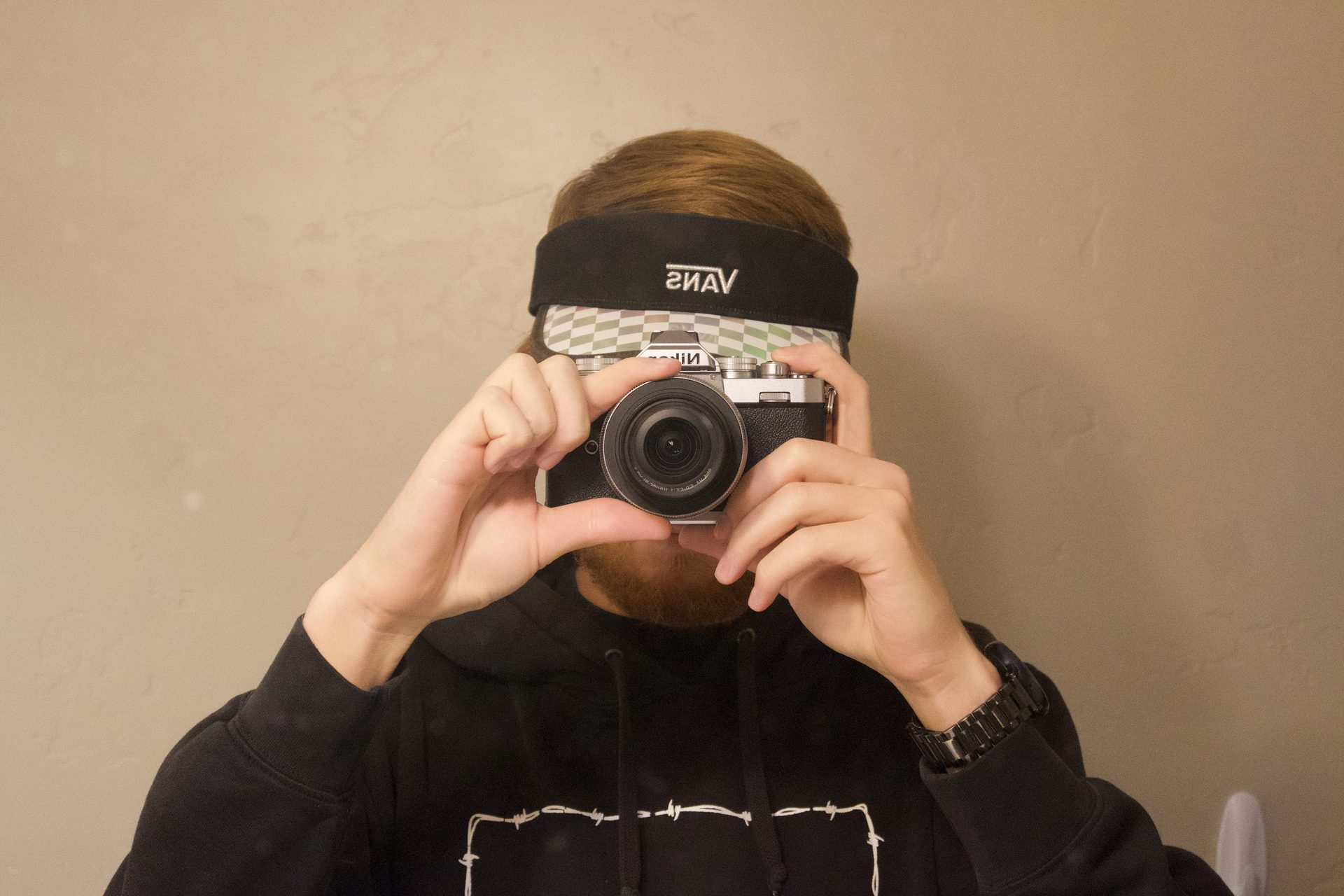 Portrait of the photographer holding a camera to his face